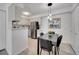 Bright kitchen with white cabinets, stainless steel appliances, and an adjacent dining area at 11985 E Harvard Ave # 108, Aurora, CO 80014