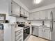 Modern kitchen featuring white cabinets, stainless steel appliances, and quartz countertops at 11985 E Harvard Ave # 108, Aurora, CO 80014