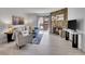 Inviting living room featuring a stone fireplace and sliding glass doors to a balcony at 11985 E Harvard Ave # 108, Aurora, CO 80014