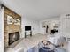 Open living room with fireplace, TV area, and adjacent dining space at 11985 E Harvard Ave # 108, Aurora, CO 80014