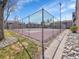 Community tennis court featuring views of the apartment complex, as well as rocks and grass at 11985 E Harvard Ave # 108, Aurora, CO 80014