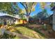 Landscaped backyard with patio, large tree, and shed at 1303 Newport St, Denver, CO 80220
