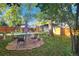 Spacious backyard with patio seating and mature tree at 1303 Newport St, Denver, CO 80220