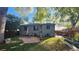 Charming home with a spacious backyard, patio, and mature trees at 1303 Newport St, Denver, CO 80220
