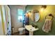 Updated bathroom with pedestal sink and stylish decor at 1303 Newport St, Denver, CO 80220