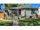 Charming bungalow with a welcoming front porch and well-maintained landscaping at 1303 Newport St, Denver, CO 80220