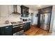 Updated kitchen featuring dark cabinetry and a farmhouse sink at 1303 Newport St, Denver, CO 80220