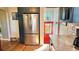 Eat-in kitchen with stainless steel refrigerator and red door access at 1303 Newport St, Denver, CO 80220