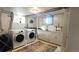 Basement laundry room with washer, dryer, and utility sink at 1303 Newport St, Denver, CO 80220