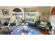 Cozy living room featuring a green sofa and large windows at 1303 Newport St, Denver, CO 80220