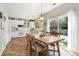 Bright kitchen with white cabinets, wood countertops, stainless appliances, and dining area at 22142 E Belleview Place, Aurora, CO 80015