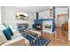 Open living room with wood floors, a fireplace, and modern furnishings at 22142 E Belleview Place, Aurora, CO 80015