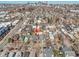An aerial view showcases a charming neighborhood with a clear view of the city skyline in the distance at 169 W Byers Pl, Denver, CO 80223