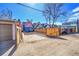 Gated backyard offers parking or potential patio space, complemented by wooden fences and exterior brick at 169 W Byers Pl, Denver, CO 80223