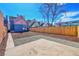 Spacious backyard with a concrete patio, wooden fence, and freshly laid mulch, perfect for entertaining at 169 W Byers Pl, Denver, CO 80223