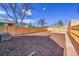 Large backyard featuring a new wooden fence, providing privacy and a safe space for outdoor activities at 169 W Byers Pl, Denver, CO 80223
