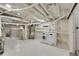 Unfinished basement features a laundry area with washer and dryer, and a water heater at 169 W Byers Pl, Denver, CO 80223