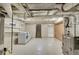 Unfinished basement features a laundry area with washer and dryer, and exposed piping and ceiling at 169 W Byers Pl, Denver, CO 80223