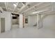 Unfinished basement with exposed ceiling beams offers potential for customization and expansion at 169 W Byers Pl, Denver, CO 80223