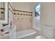 Well-lit bathroom featuring stylish tile, a bathtub, and a modern sink, providing a fresh and clean feel at 169 W Byers Pl, Denver, CO 80223