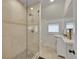 Bathroom boasts tiled shower with glass door, complemented by a modern sink and vanity at 169 W Byers Pl, Denver, CO 80223