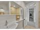 Bathroom features a sink and vanity area with a mirrored wall and tiled shower with glass door at 169 W Byers Pl, Denver, CO 80223