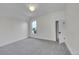 Cozy bedroom features gray carpet, white walls, and a window with a view of the outdoors at 169 W Byers Pl, Denver, CO 80223