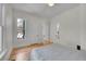 Bright bedroom featuring hardwood floors, neutral walls, and a comfortable bed by a bright window at 169 W Byers Pl, Denver, CO 80223