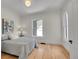 Sunlit bedroom showcasing hardwood floors, neutral walls, and a comfortable bed by a bright window at 169 W Byers Pl, Denver, CO 80223