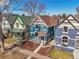 Charming blue two-story home with inviting front yard and sidewalk appeal in a desirable neighborhood at 169 W Byers Pl, Denver, CO 80223