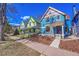 Charming street view showcasing colorful, well-maintained Victorian-style homes under a clear blue sky at 169 W Byers Pl, Denver, CO 80223