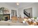 Open-concept living room featuring hardwood floors, a fireplace, and a seamless transition to the dining area at 169 W Byers Pl, Denver, CO 80223