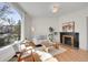 Bright living room featuring a classic fireplace, hardwood floors, and a large arched window at 169 W Byers Pl, Denver, CO 80223