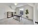 Bright office space features a dark work desk, shelving, and a large plant, offering a modern workspace at 169 W Byers Pl, Denver, CO 80223