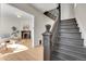 Elegant staircase featuring dark wood with decorative details, bright living room view at 169 W Byers Pl, Denver, CO 80223