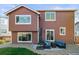 The backyard features a patio seating area, gravel ground cover, and a well-maintained lawn at 11373 Kearney Way, Thornton, CO 80233