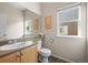 Bright bathroom with a single sink vanity, tiled floor, and a window to let in natural light at 11373 Kearney Way, Thornton, CO 80233