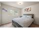 Comfortable bedroom with a large window, carpeted floors, and a gray bed frame and bedding set at 11373 Kearney Way, Thornton, CO 80233