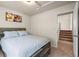 Bedroom showcasing carpeted floors, a painting, and a partial view of the staircase at 11373 Kearney Way, Thornton, CO 80233
