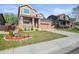 Charming two-story home with brick accents, a well-manicured lawn, and a cozy front porch at 11373 Kearney Way, Thornton, CO 80233