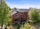 Exterior view of a two-story home with a well-kept lawn and patio seating at 11373 Kearney Way, Thornton, CO 80233