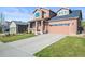 Beautiful home featuring brick accents, a spacious driveway, and a well-maintained lawn at 11373 Kearney Way, Thornton, CO 80233
