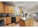 Bright kitchen featuring wood cabinets, black appliances, and ample counter space at 11373 Kearney Way, Thornton, CO 80233