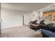 Comfortable living room with a dark brown sofa, coffee table and view to the kitchen area at 11373 Kearney Way, Thornton, CO 80233