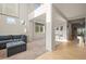 Open concept living room boasts high ceilings, bright windows, and a seamless flow into the adjacent dining area at 11373 Kearney Way, Thornton, CO 80233