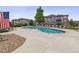 Relax at the community pool with views of residential buildings, lounge chairs, and an American flag waving in the breeze at 1466 Turnberry Dr, Castle Rock, CO 80104