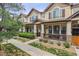 Inviting townhome featuring a covered porch, neat landscaping, and appealing curb appeal at 1466 Turnberry Dr, Castle Rock, CO 80104