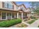 Charming townhome exterior with a covered porch, manicured landscaping, and classic architectural details at 1466 Turnberry Dr, Castle Rock, CO 80104