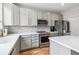 Well-lit kitchen featuring stainless steel appliances, gray cabinetry, and white countertops at 1466 Turnberry Dr, Castle Rock, CO 80104