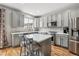 Open concept kitchen featuring a large island, stainless steel appliances, and grey cabinetry at 1466 Turnberry Dr, Castle Rock, CO 80104